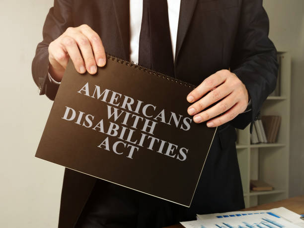 istock Lawyer holds Americans with Disabilities Act ADA book. 1197632247