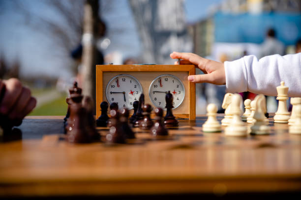 Pressing chess clock Young person is pressing chess clock chess timer stock pictures, royalty-free photos & images