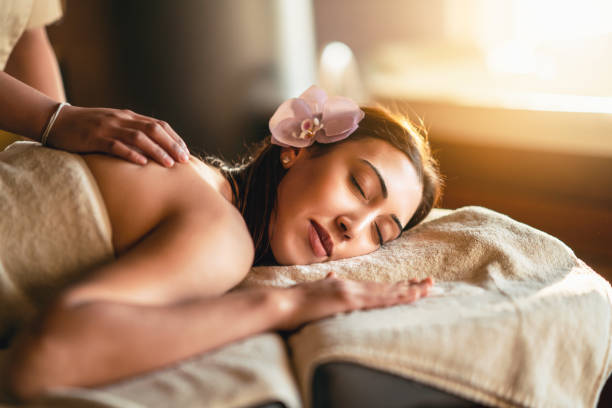 Happiness on woman's face having relaxing thai massage stock photo