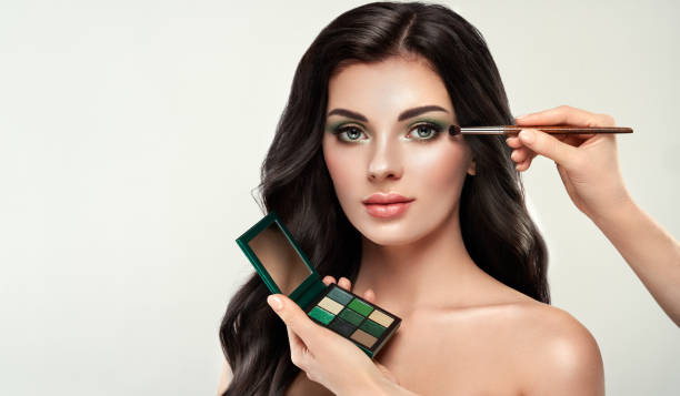 istock Makeup artist applies eye shadow 1197644618