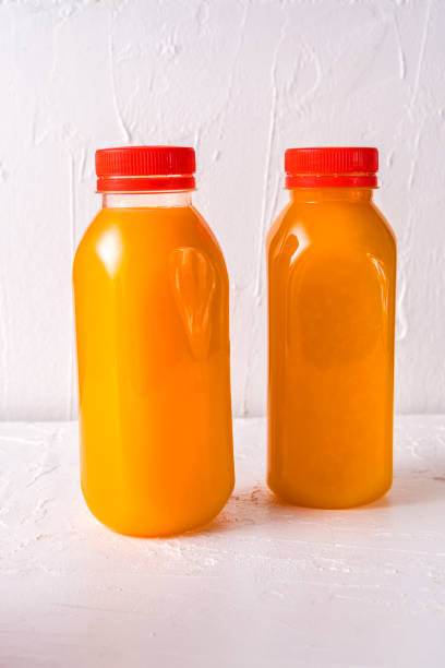 istock Bottles with drink or smoothies on white background. Flat lay, top view. 1197646395