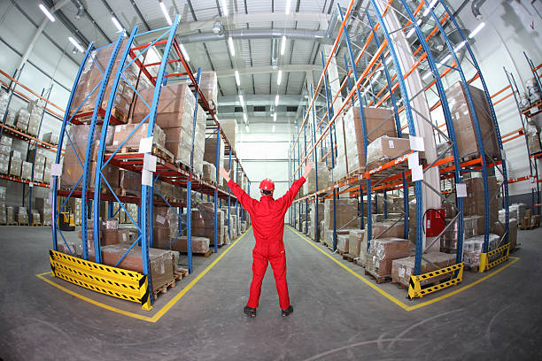 istock worker  raising hands in the middle of warehouse 119764788