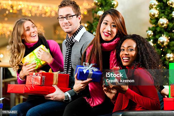 Friends With Christmas Presents And Bags In Mall Stock Photo - Download Image Now - Adult, Adults Only, African Ethnicity