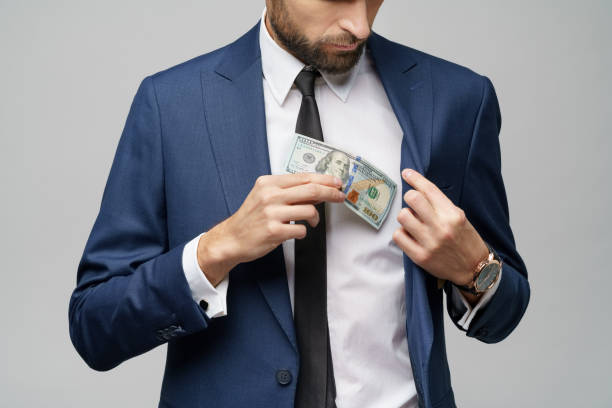 istock young handsome businessman holding US dollar bill 1197648526