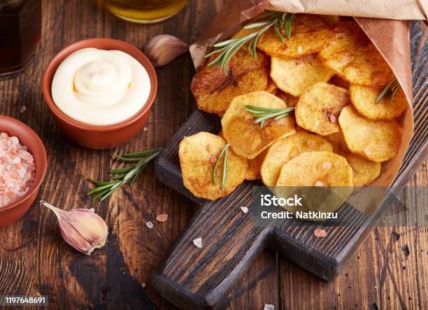 Crispy Potato Chips Slices Of Potato Roasted With Sea Salt And Rosemary Stock Photo - Download Image Now