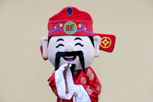 God of Prosperity imitate using smartphone for online communication cheerfully.