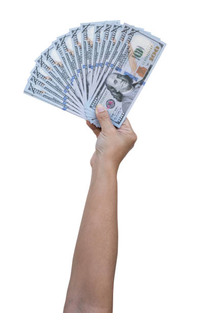 istock hundreds of dollars in rise up hand on a white background 1197648904