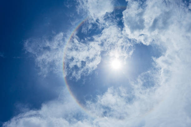 istock Sun halo with blue sky background with white clouds. 1197649873