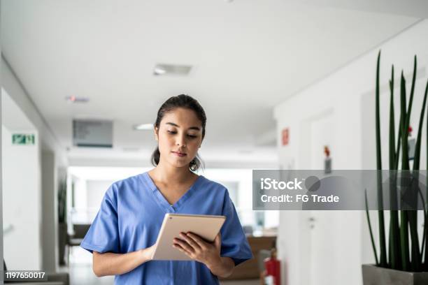 Krankenschwester Zu Fuß Und Mit Tablet Im Krankenhaus Stockfoto und mehr Bilder von Krankenpflegepersonal