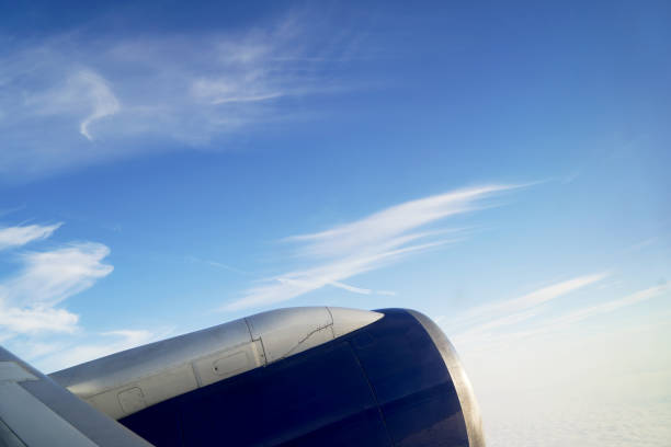 istock View from airplane window engine and wing flying above the clouds 1197656667