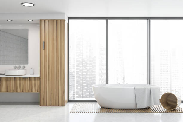 istock White tile panoramic bathroom, sink and tub 1197656933