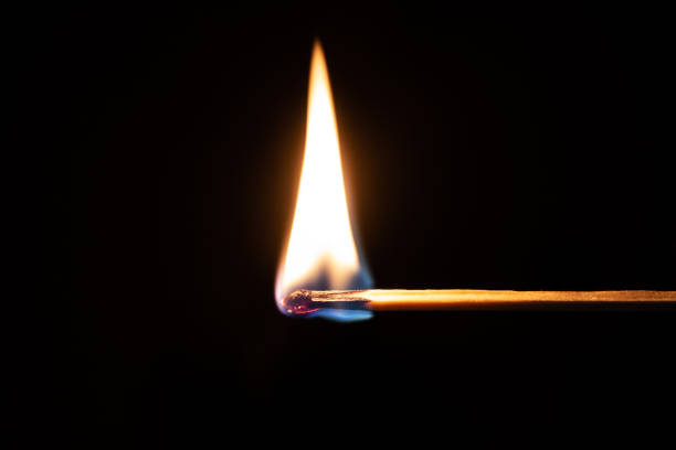 One quiet burning match on black background. Match burning details