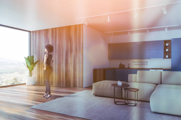 istock Woman in blue kitchen corner with sofa 1197657739