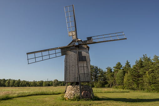 Grain mill on the summer landscape. Windmill and natural background pattern. Hiiumaa, small island in Estonia. Europe