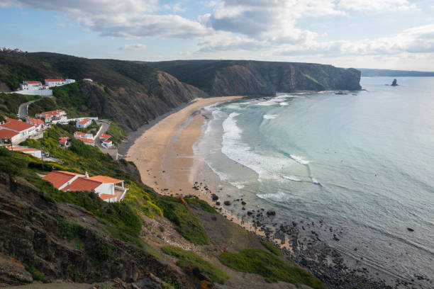 istock Praia da Arrifana beach with surfers on the atlantic ocean 1197658128