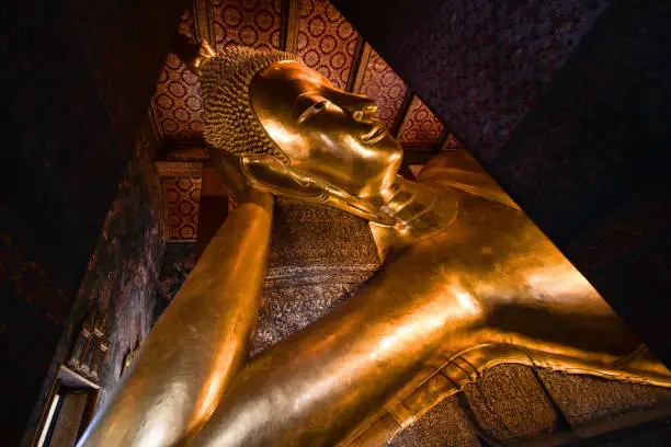 Photo of famous golden reclining buddha statue at wat pho bangkok thailand