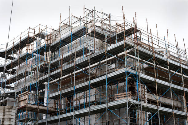 istock Concrete building under construction in scaffolding. 1197663615