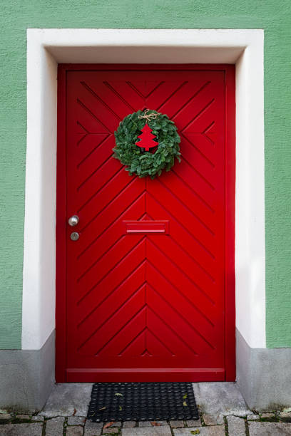 Red door with Advent wreath (door wreath) in Germany
