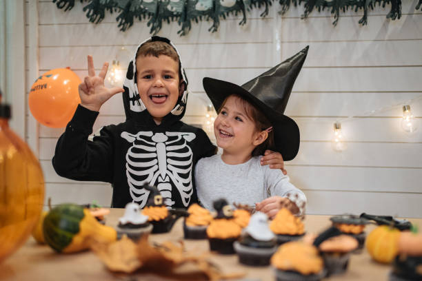 istock Playful brother and sister celebrating Halloween 1197664677