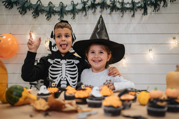 istock Cheerful siblings enjoying Halloween together at home 1197664796