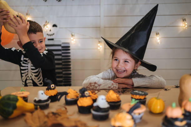 istock Cute children enjoying Halloween at home 1197664943
