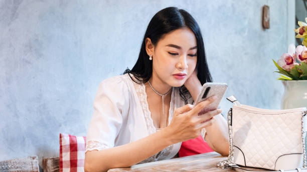 istock Young asian woman watching and using mobile 1197665089
