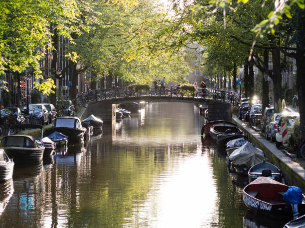 Amsterdam canal tranquill evening scene Tranquil evening scene with the sun setting on Amsterdam's Bloemgracht in the Dutch city's old Jordaan neighbourhood. jordaan amsterdam stock pictures, royalty-free photos & images