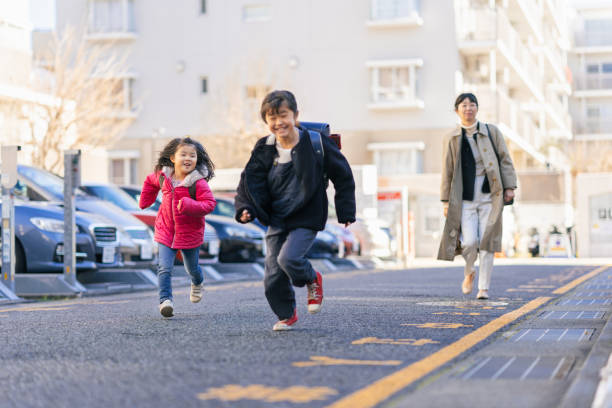 istock Working mother and sisters walking to car 1197669051