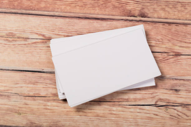 istock empty white business cards on a light natural wooden background 1197669444