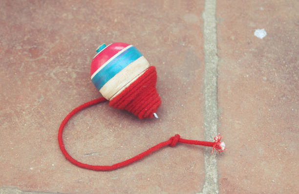istock Classic wooden spinning top toy with string 1197670379