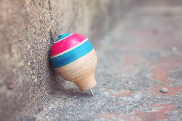 istock Classic wooden spinning top toy with string 1197670381