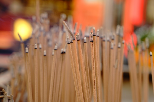 Picture of many incense sticks placed on a joss stick pot as a merit-making ritual in a Chinese temple, Chiang Mai, Thailand.