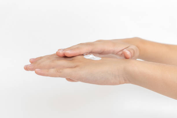 istock Hand skin care. Closeup on woman's hands applying moisturizing hand cream on 1197674582