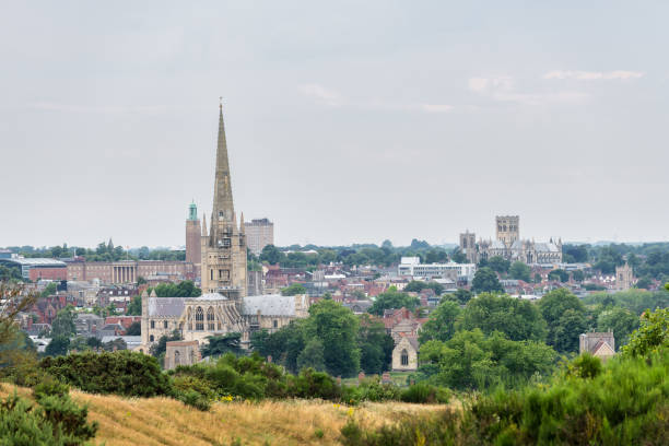 Norwich skyline from a nearby hill Skyline of Norwich in East England on a cloudy day, with both cathedrals to be recognised. norman uk tree sunlight stock pictures, royalty-free photos & images