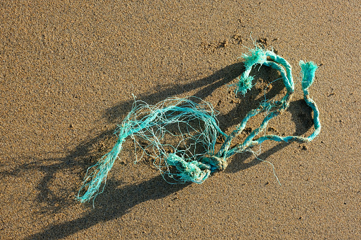 Garbage and remnants of tangled rope on a beach on the southeastern coast of Brazil