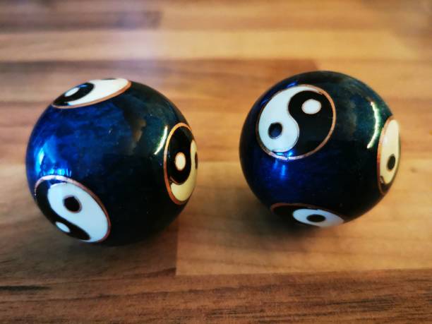 Qi Gong Ball Yin-Yang Blue on a wooden table in brown and blue and white and golden colors for meditation and relaxation