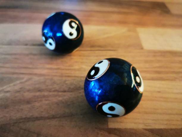 Qi Gong Ball Yin-Yang Blue on a wooden table in brown and blue and white and golden colors for meditation and relaxation
