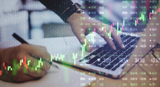 istock Global trading concept with business chart screen and businessman using laptop and making notes. Double exposure. 1197675697