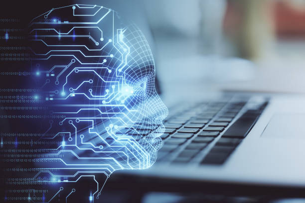 istock Sideview of laptop with head outline 1197675738