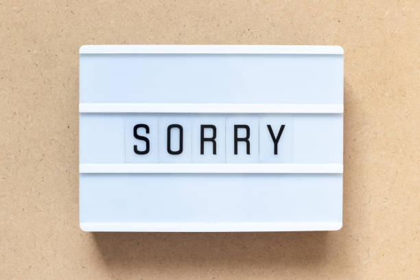 istock White lightbox with word sorry on wood background 1197676634
