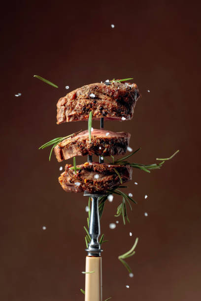 istock Grilled ribeye beef steak with rosemary on a brown background. 1197677112