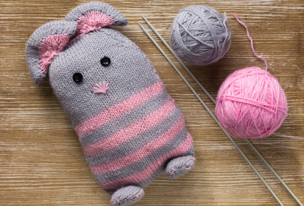 istock Handmade knitting mouse on the wooden background 1197677327