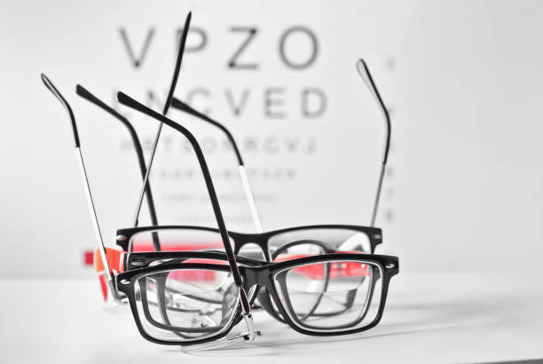istock Glasses on a white background. Background with letters for vision test. 1197678031
