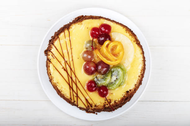 istock cake with cream and berries on a white wooden table 1197681073