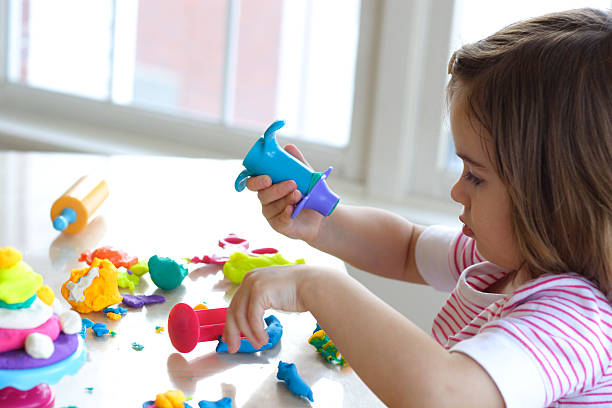 istock Girl playing with play dough 119768277