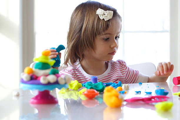 istock Girl playing with play dough 119768279