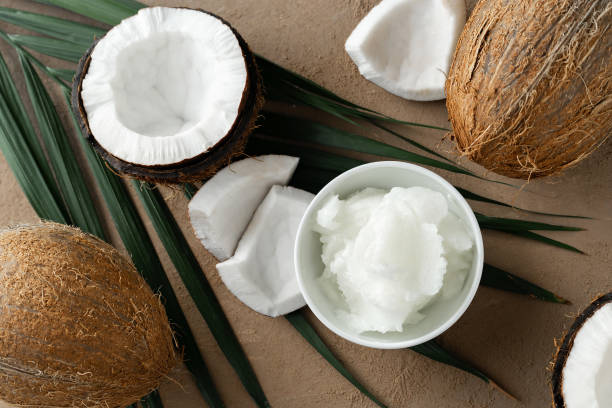 istock ripe coconuts and coconut oil on brown background 1197683324