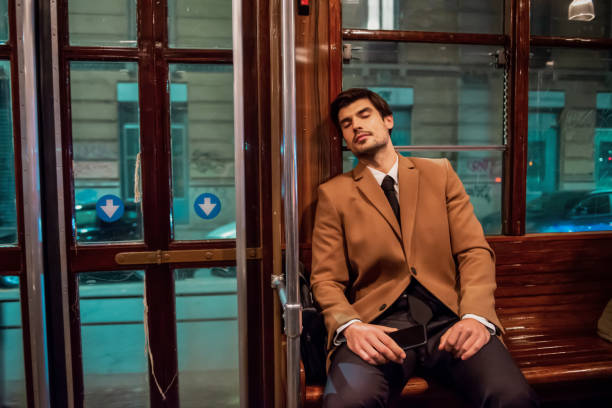 businessman in formal wear sitting in public transportation