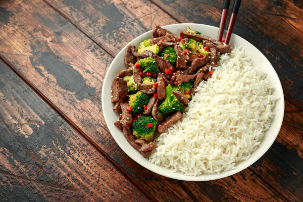 istock Homemade Beef and Broccoli with Rice on wooden table 1197684773