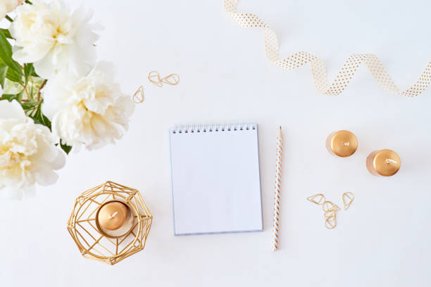 istock Mockup white notebook with white peonies on a white background 1197686150